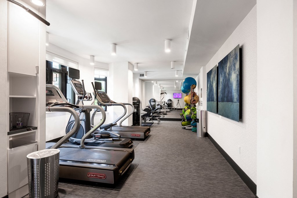a gym with treadmills and other exercise equipment