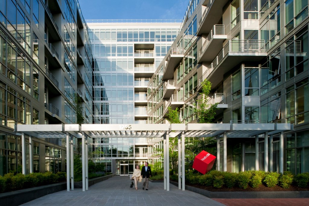 people walking in front of an office building