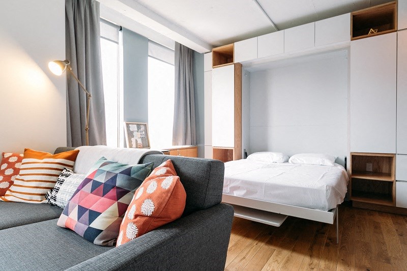 a bedroom with a couch and a bed in a hotel room