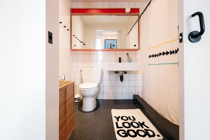 a bathroom with a toilet and a sign that says you look good