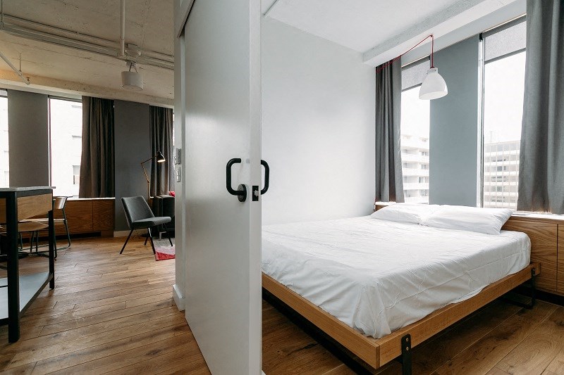 a bedroom with a bed and a sliding glass door