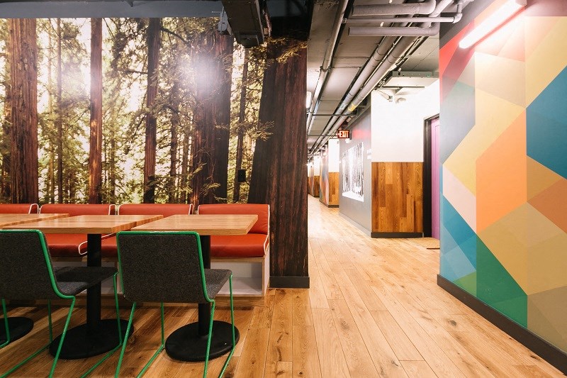 a dining room with a forest mural on the wall and tables and chairs