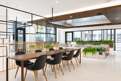 a large dining room with a long wooden table and chairs