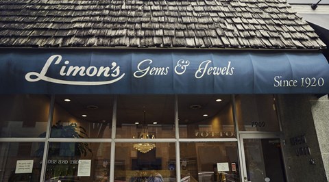 a store front with a blue awning and the wordslimons jeans and
