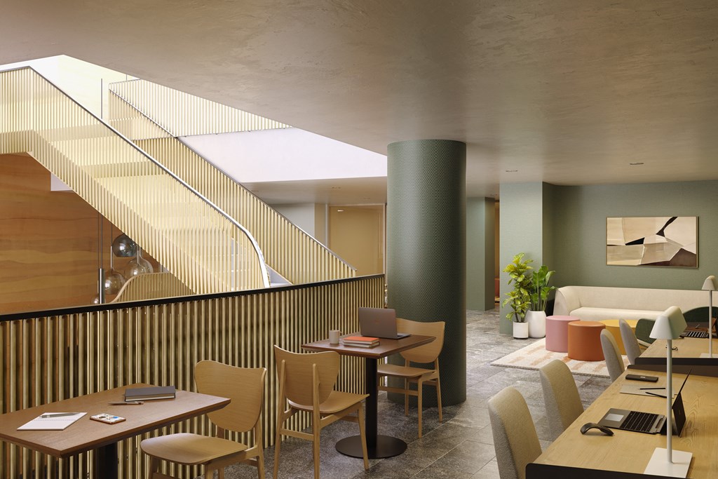 a restaurant with tables and chairs and a staircase