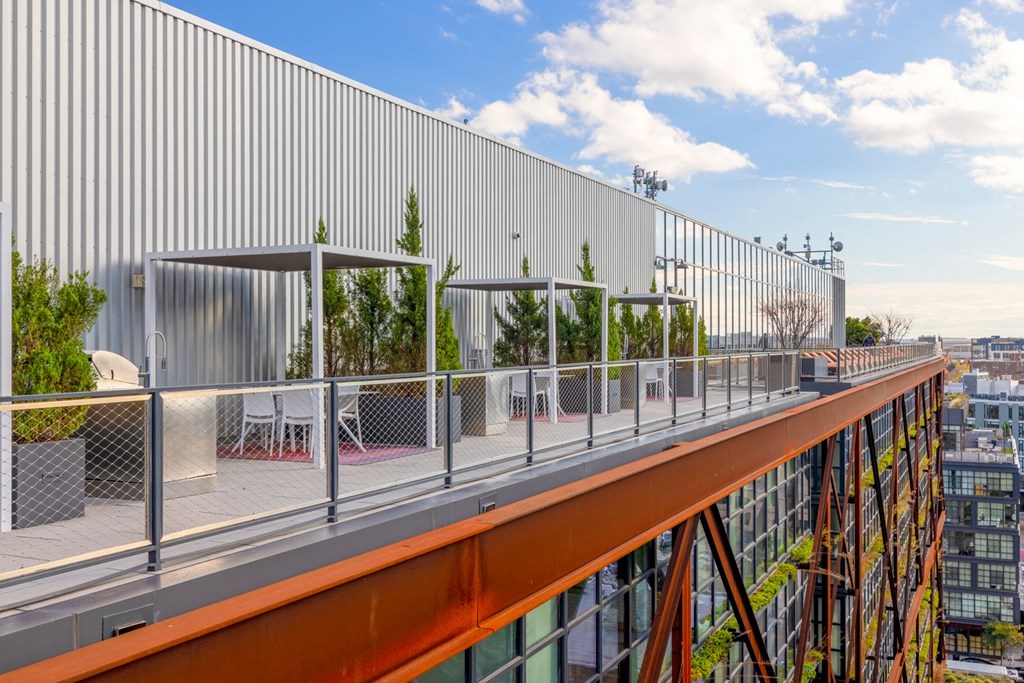 the roof of a building with a balcony and a view of the city