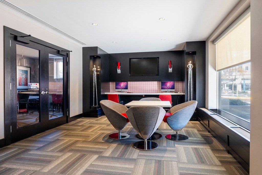 a dining room with a table and chairs and a tv on the wall