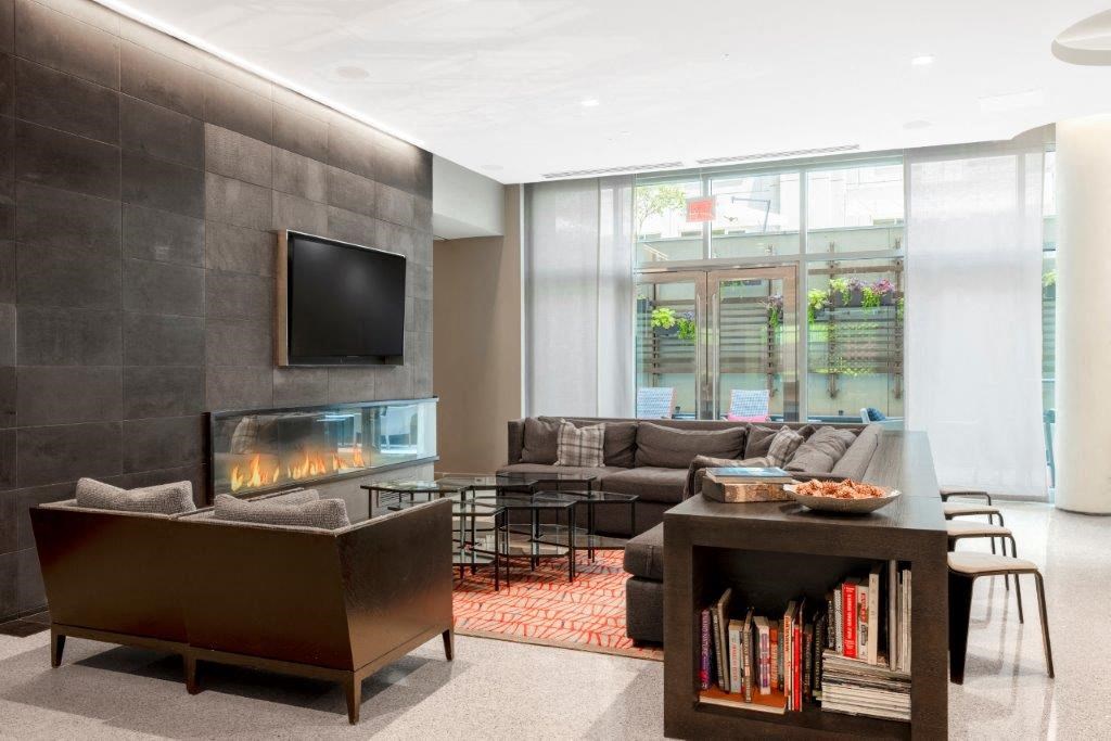 a large living room with a fireplace and a television