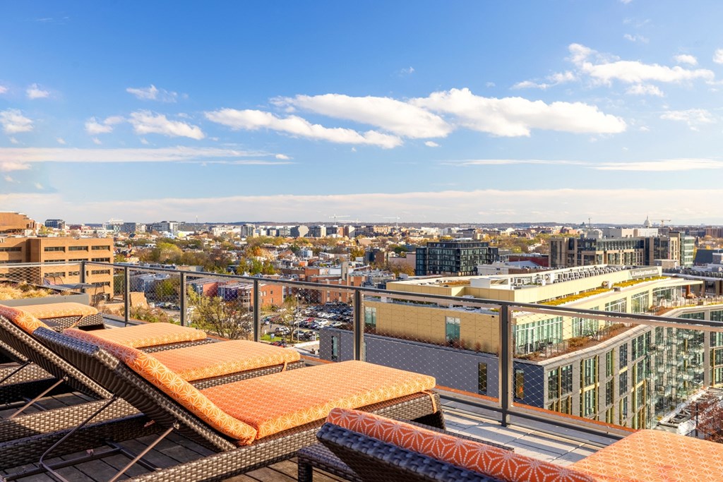 a view of the city from a rooftop terrace of a building