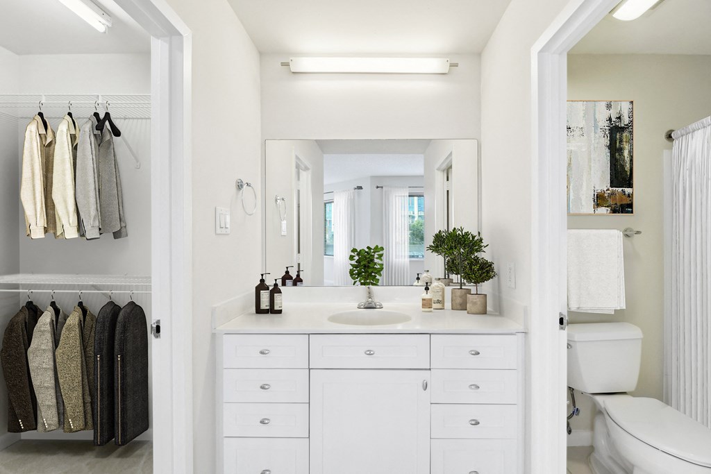 a white bathroom with a sink and a mirror