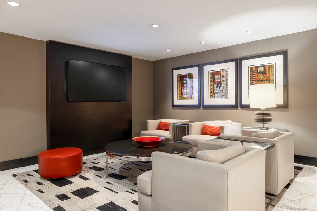 a living room with couches and a table and a television