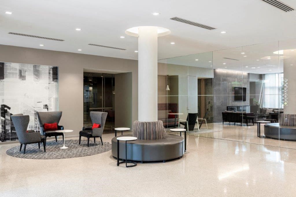 a large lobby with chairs and a table