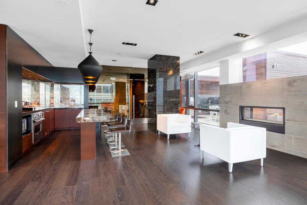 a large kitchen and living room with white furniture and a fireplace
