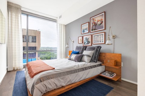 a bedroom with a bed and a large window