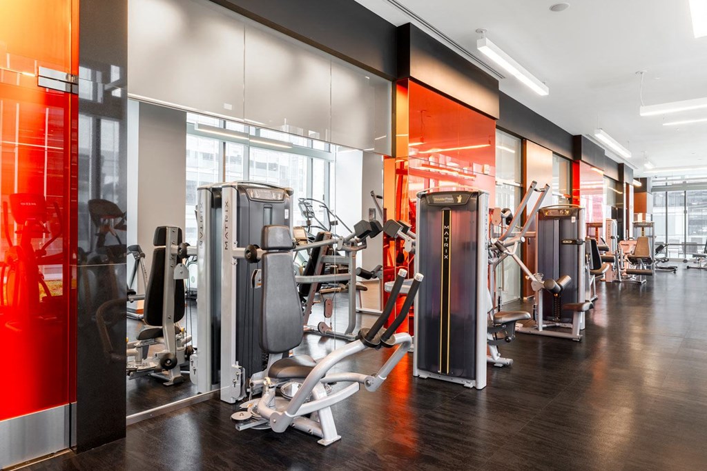 a gym with weights and cardio equipment in a building