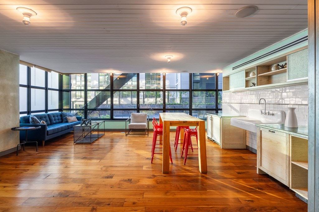 a living room with a kitchen and a table with chairs
