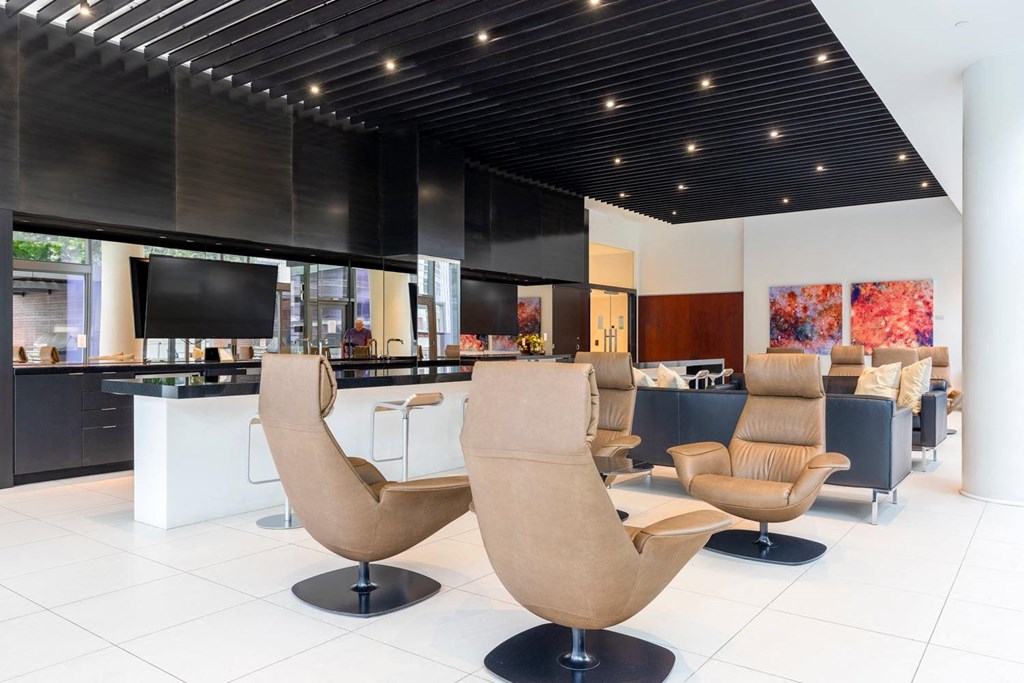 a lounge area with chairs and a bar