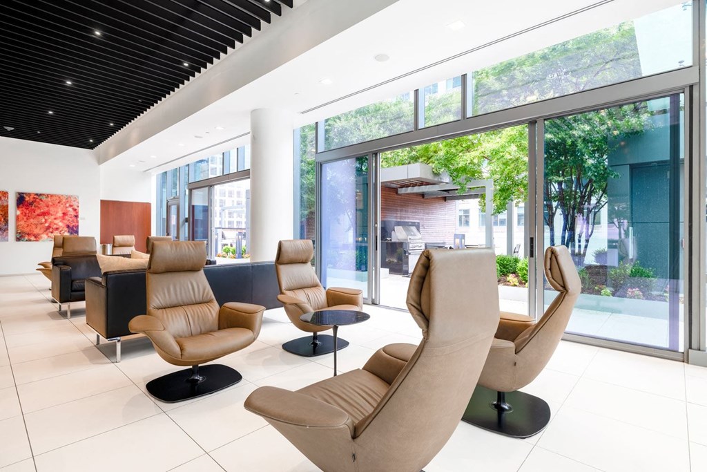 a lobby with chairs and a large window