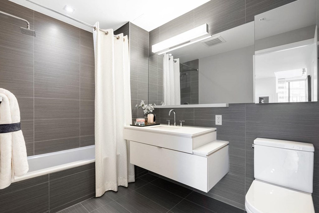 a bathroom with a sink and a toilet and a mirror