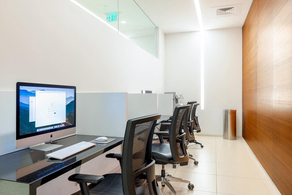 an office with a desk with a computer on it
