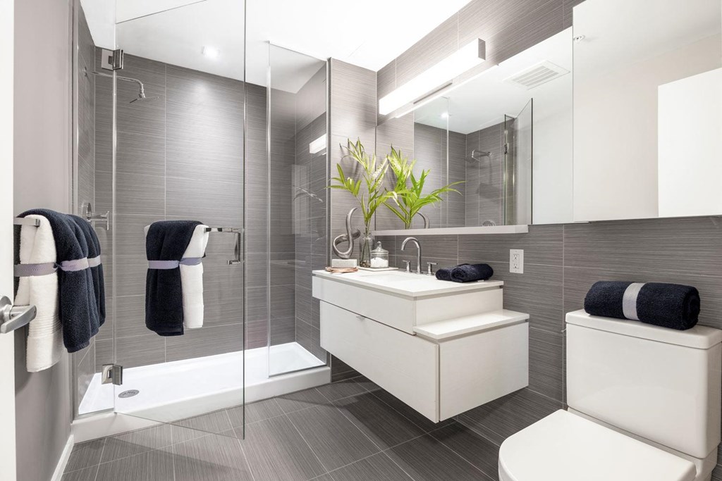 a bathroom with a sink and a toilet and a shower