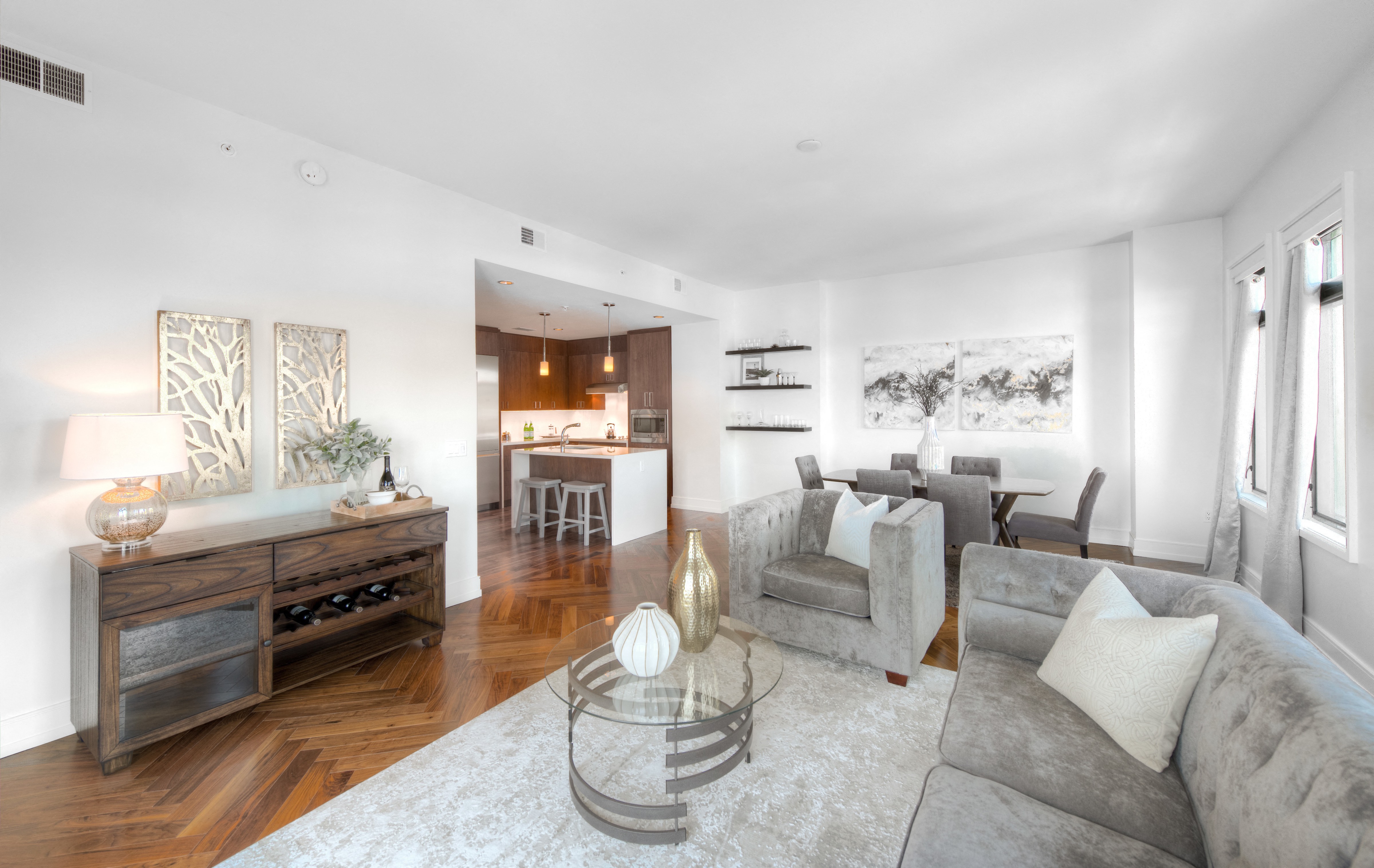 a living room with couches and a glass table