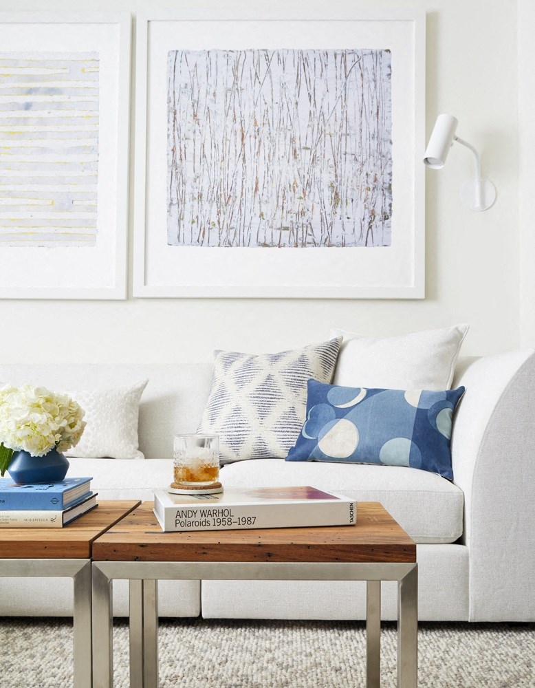 a living room with a white couch and a wooden coffee table