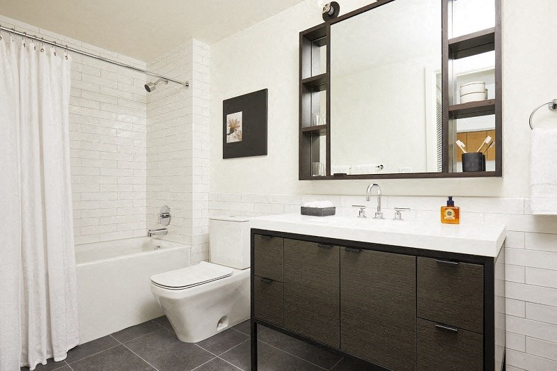 a bathroom with a toilet sink and a mirror