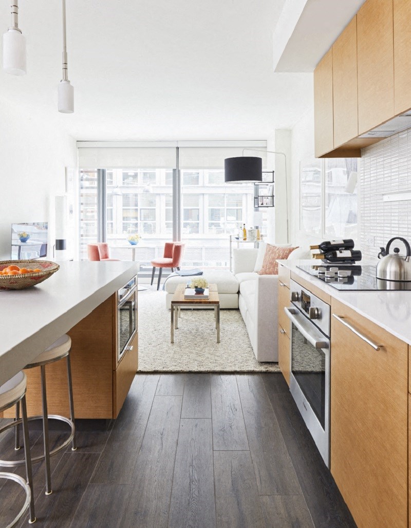 a view of a living room and kitchen with a couch and a table