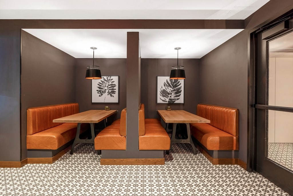 a dining room with two tables and two benches and two chairs