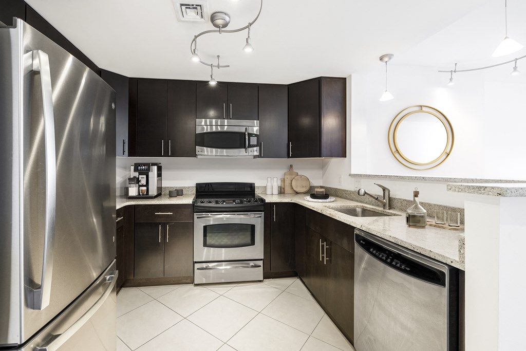 a kitchen with stainless steel appliances and black cabinets a kitchen with stainless steel appliances and black cabinets at 220 Twentieth Street, Virginia