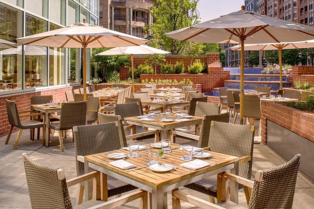 a restaurant patio with tables and chairs and umbrellas