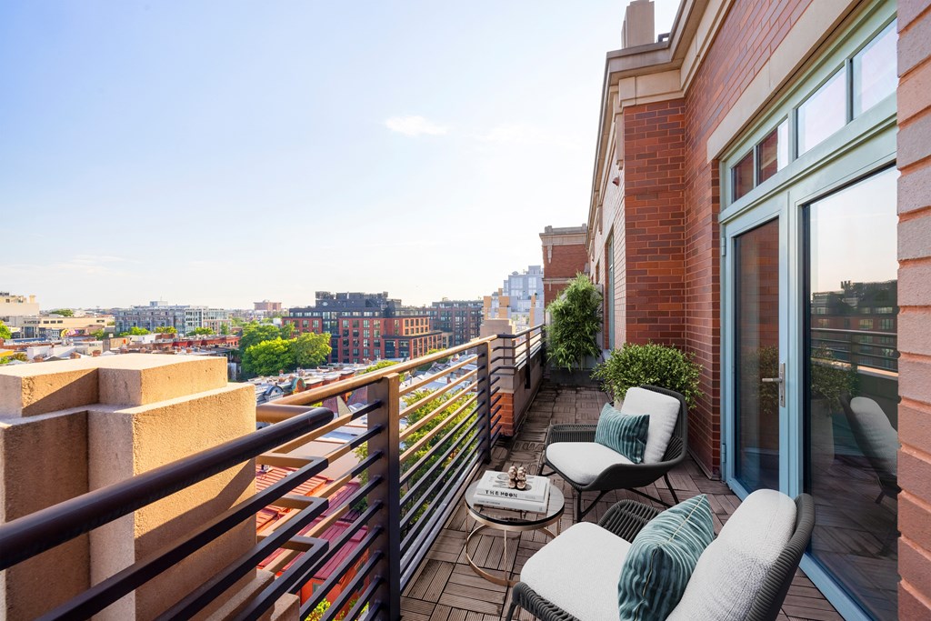 a balcony with furniture and a view of the city