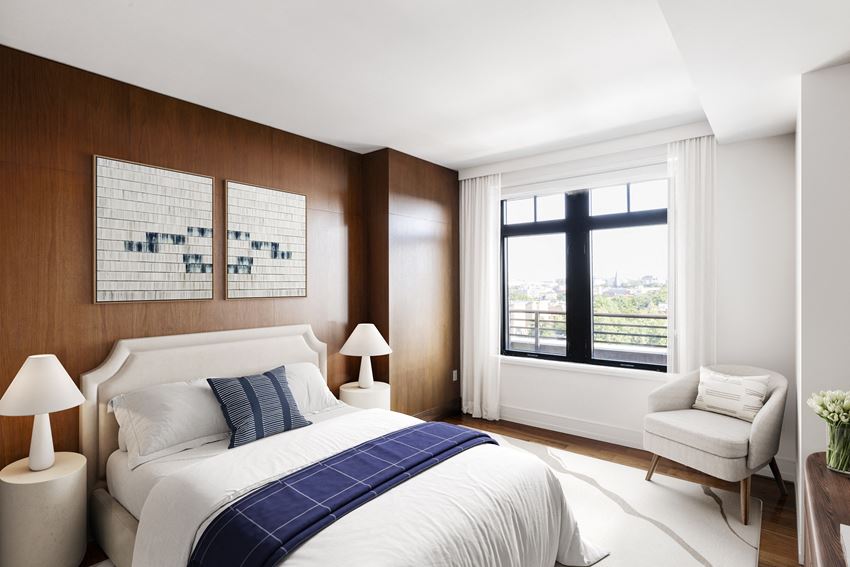 a bedroom with a bed and a window