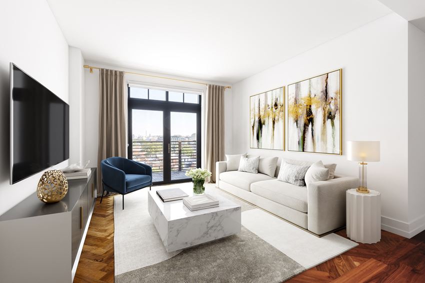a living room with a white couch and a television