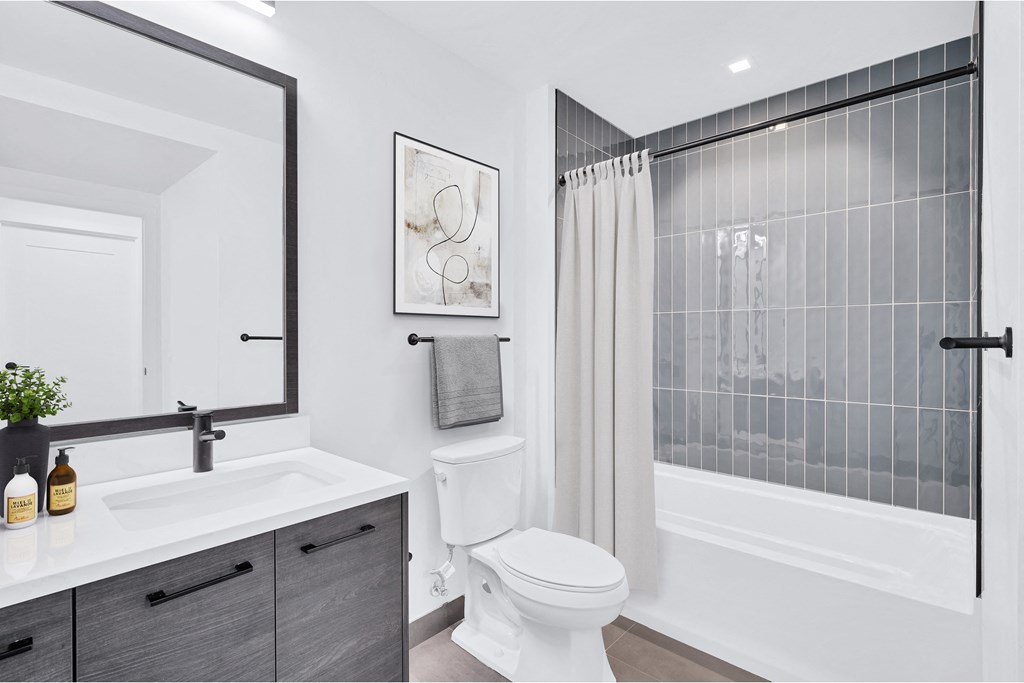 a bathroom with a shower and a toilet and a sink