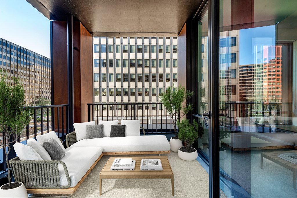 a living area with a couch and a table on a balcony