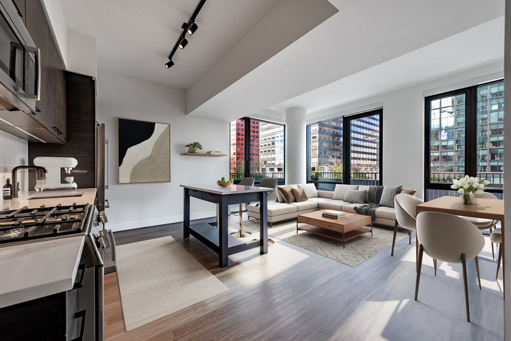 a living room with a kitchen and a couch and a table