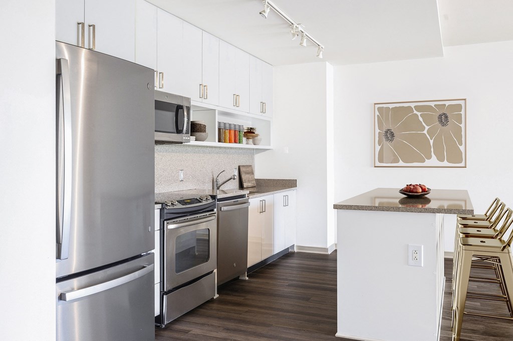 a kitchen with white cabinets and stainless steel appliances
