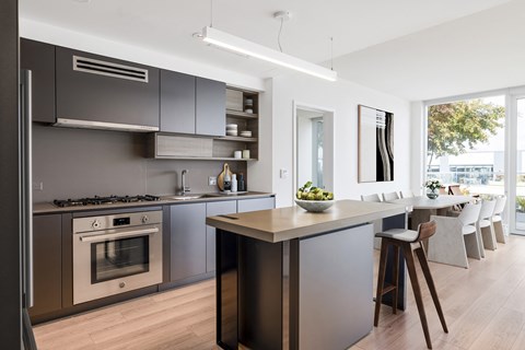 a kitchen and dining area with stainless steel appliances and a counter top