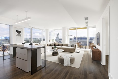 an open living room with a kitchen and a living room