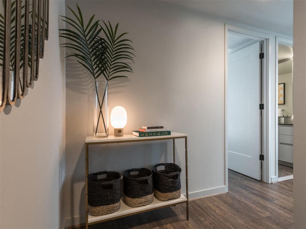 a living room with a plant and a table