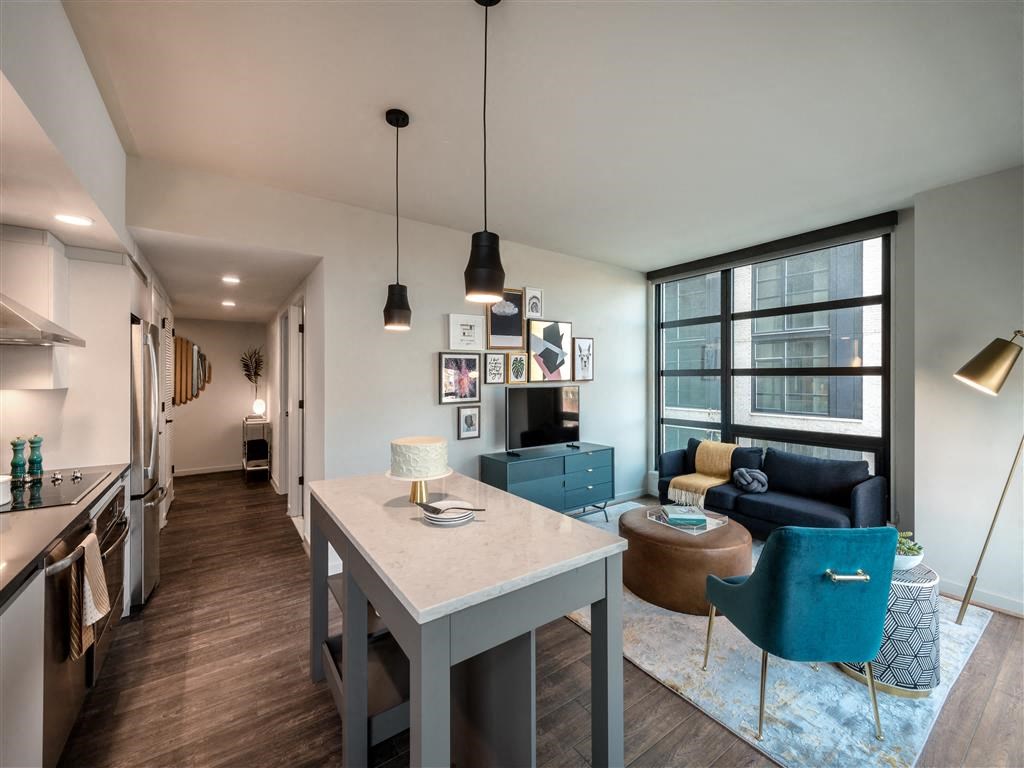 a living room and dining room area with a white table and chairs