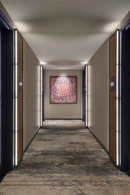 a hallway with a painting on the wall and doors