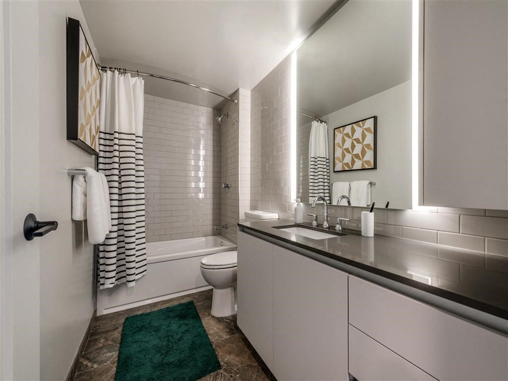 a bathroom with a sink and a toilet and a bath tub