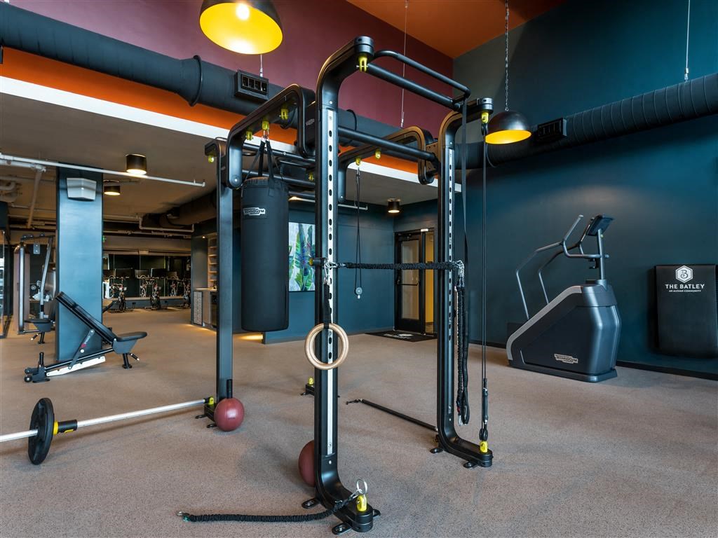 a workout room with weights and other equipment at the flats at big tex apartments in san an