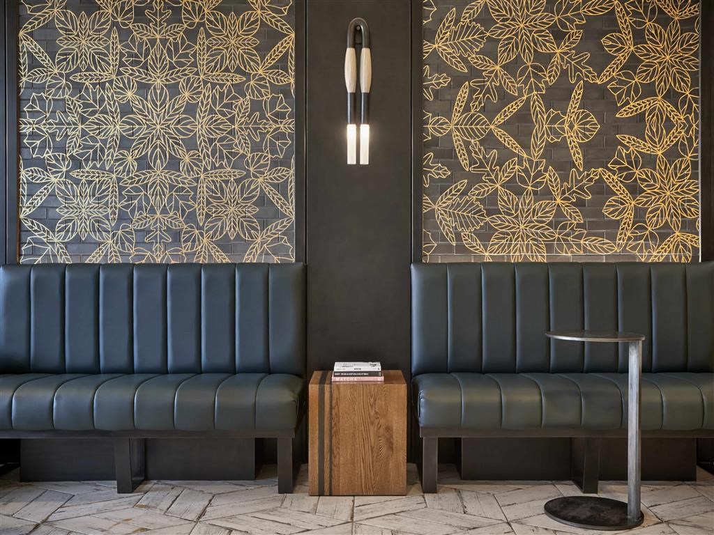 a lobby with two blue couches and a coffee table