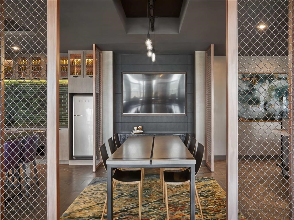 a dining room with a table and chairs and a television