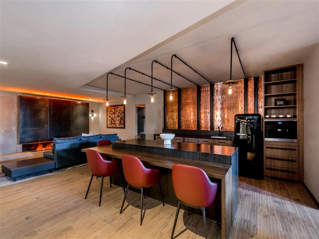 a kitchen and living room with a table and chairs