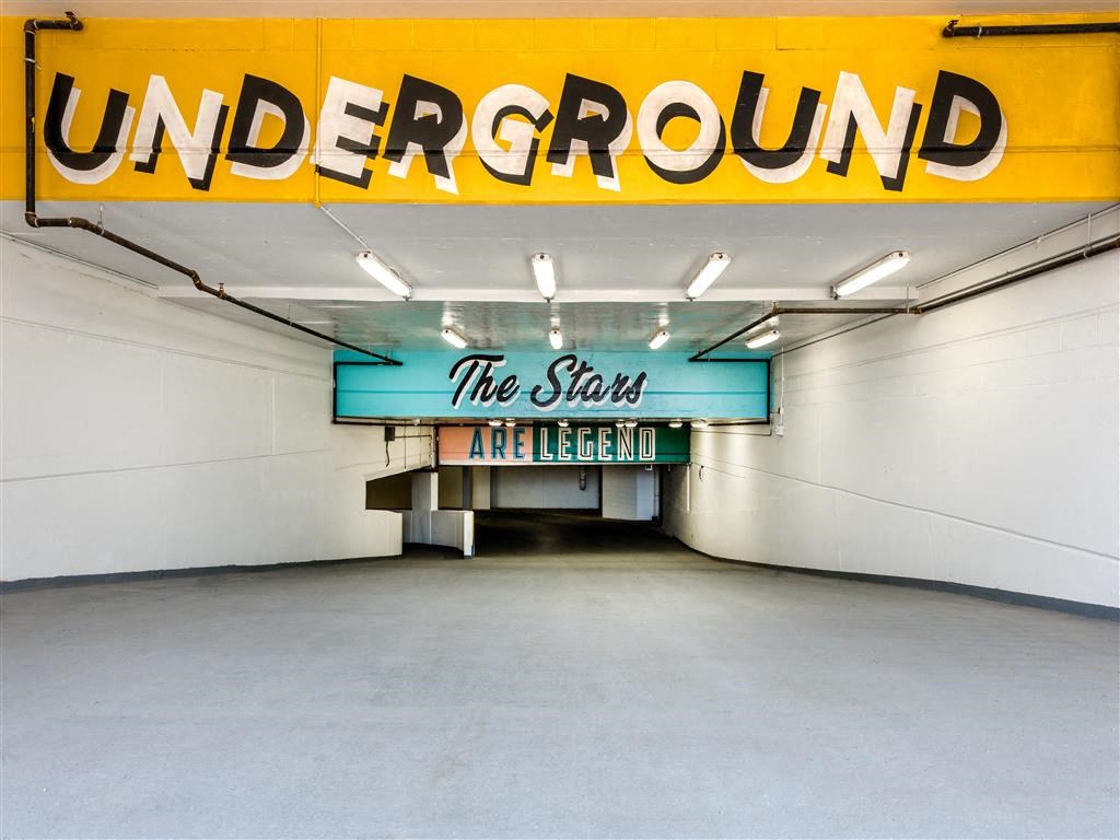 a parking garage with a sign that reads the stars are eternal